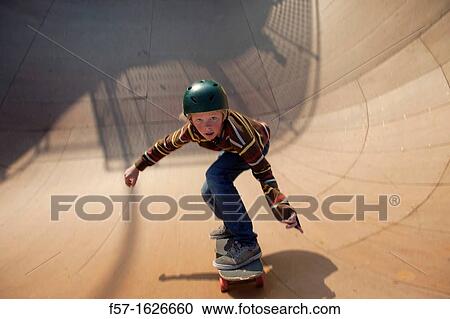 Young teenager skateboarding in a bowl View Large Photo Image Stock Image - Young teenager skateboarding in a bowl. Fotosearch