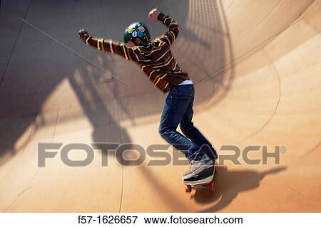 Young teenager skateboarding in a bowl View Large Photo Image Stock Photo - Young teenager skateboarding in a bowl. Fotosearch