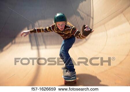 Young teenager skateboarding in a bowl View Large Photo Image Stock Photo - Young teenager skateboarding in a bowl. Fotosearch