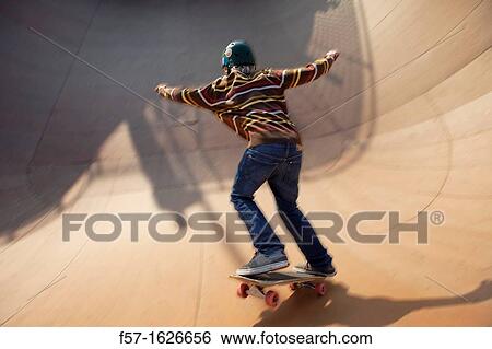 Young teenager skateboarding in a bowl View Large Photo Image Stock Photograph - Young teenager skateboarding in a bowl. Fotosearch