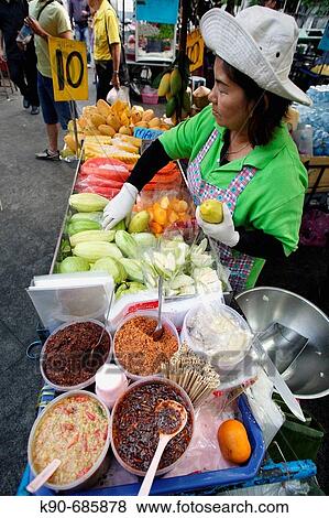 Young thai lady selling freshly cut tropical fruits on a street market neas the Grand Palace in Bangkok, the City of Angels, Thailand, Southeast Asia View Large Photo Image Stock Photo - Young thai lady selling freshly cut tropical fruits on a street market neas the Grand Palace in Bangkok, the City of Angels, Thailand, Southeast Asia. Fotosearch
