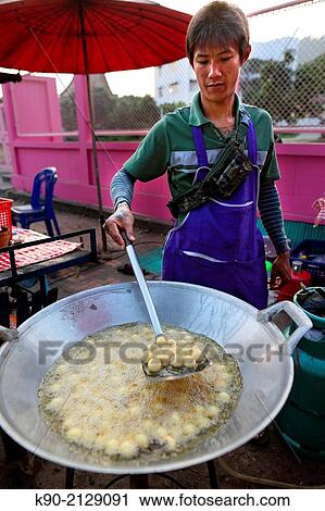Young Thai man frying rice flavour balls in hot oil, Mae Hong Son, Thailand, Southeast Asia. View Large Photo Image Stock Image - Young Thai man frying rice flavour balls in hot oil, Mae Hong Son, Thailand, Southeast Asia.. Fotosearch