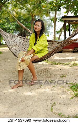 Young thai woman sitting in hammock, Koh Jum Lodge, Koh Jum Island, Krabi, Thailand, Asia View Large Photo Image Stock Image - Young thai woman sitting in hammock, Koh Jum Lodge, Koh Jum Island, Krabi, Thailand, Asia. Fotosearch