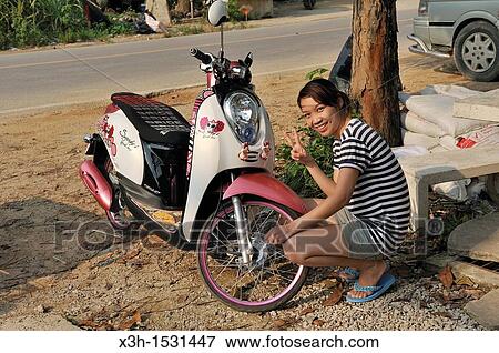Young thai woman with her scooter Krabi, Thailand, Asia View Large Photo Image Stock Photo - Young thai woman with her scooter Krabi, Thailand, Asia. Fotosearch