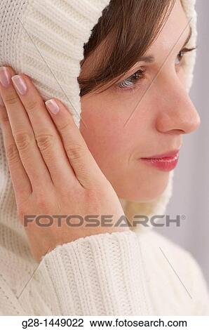 Young thoughtful woman in white woolen hood on her head, with her hands on her ears View Large Photo Image Stock Image - Young thoughtful woman in white woolen hood on her head, with her hands on her ears. Fotosearch
