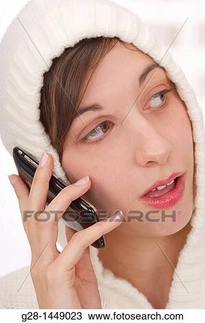 Young thoughtful woman in white woolen hood on her head, holding her phone in one hand View Large Photo Image Stock Image - Young thoughtful woman in white woolen hood on her head, holding her phone in one hand. Fotosearch