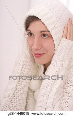 Young thoughtful woman in white woolen hood on her head, with her hands on her ears View Large Photo Image Stock Photo - Young thoughtful woman in white woolen hood on her head, with her hands on her ears. Fotosearch