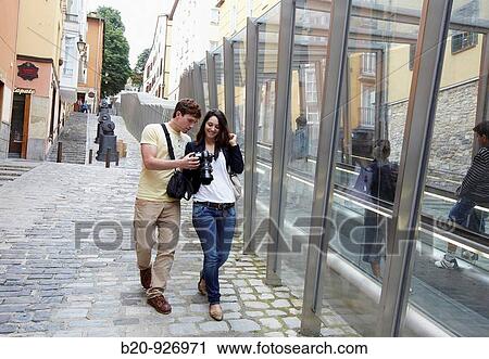 Young tourist couple. Escalator, Old town, Vitoria-Gasteiz, Alava, Basque Country, Spain View Large Photo Image Stock Image - Young tourist couple. Escalator, Old town, Vitoria-Gasteiz, Alava, Basque Country, Spain. Fotosearch