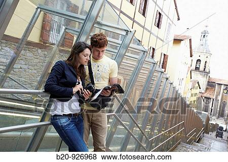 Young tourist couple. Escalator, Old town, San Pedro Apostol church in background, Vitoria-Gasteiz, Alava, Basque Country, Spain View Large Photo Image Stock Photo - Young tourist couple. Escalator, Old town, San Pedro Apostol church in background, Vitoria-Gasteiz, Alava, Basque Country, Spain. Fotosearch