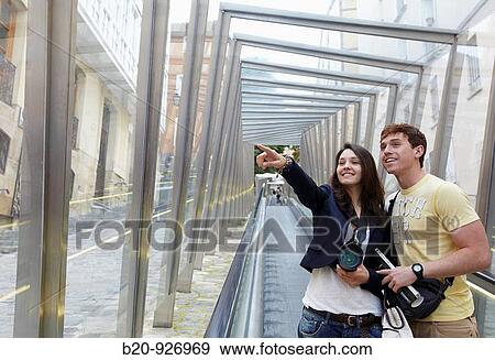 Young tourist couple. Escalator, Old town, Vitoria-Gasteiz, Alava, Basque Country, Spain View Large Photo Image Stock Photo - Young tourist couple. Escalator, Old town, Vitoria-Gasteiz, Alava, Basque Country, Spain. Fotosearch