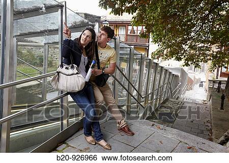 Young tourist couple. Escalator, Old town, Vitoria-Gasteiz, Alava, Basque Country, Spain View Large Photo Image Stock Photograph - Young tourist couple. Escalator, Old town, Vitoria-Gasteiz, Alava, Basque Country, Spain. Fotosearch