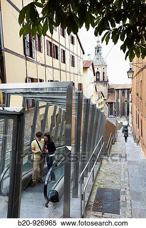 Young tourist couple. Escalator, Old town, San Pedro Apostol church in background, Vitoria-Gasteiz, Alava, Basque Country, Spain View Large Photo Image Stock Photography - Young tourist couple. Escalator, Old town, San Pedro Apostol church in background, Vitoria-Gasteiz, Alava, Basque Country, Spain. Fotosearch