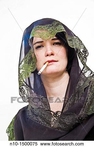 Young veiled woman with a cigarette View Large Photo Image Stock Photography - Young veiled woman with a cigarette. Fotosearch