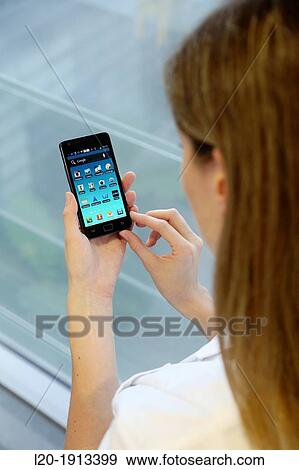 Stock Photo - Young with smartphone. Fotosearch