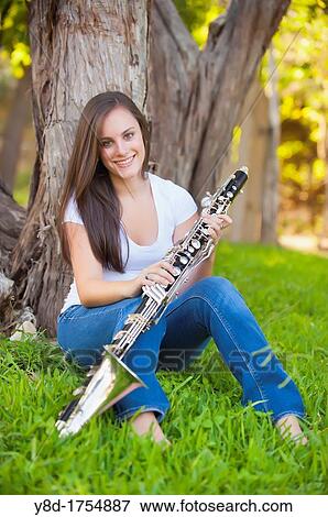 Young woman, 17 years caucasian, brunette hair, playing clarinet music instrument View Large Photo Image Stock Photo - Young woman, 17 years caucasian, brunette hair, playing clarinet music instrument. Fotosearch