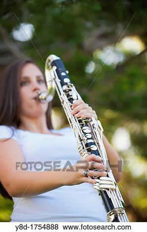 Young woman, 17 years caucasian, brunette hair, playing clarinet music instrument View Large Photo Image Stock Photo - Young woman, 17 years caucasian, brunette hair, playing clarinet music instrument. Fotosearch