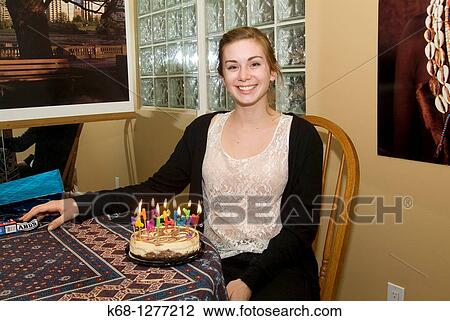 Stock Image - young woman, 19, with her birthday cake. Fotosearch