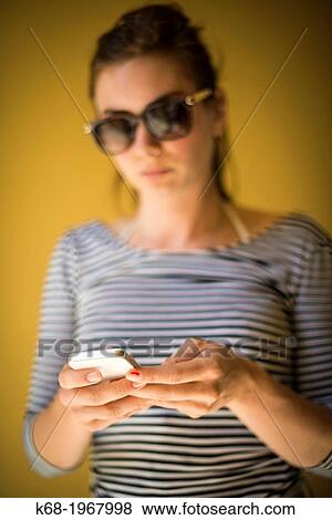 young woman, 21, using a phone. View Large Photo Image Stock Photo - young woman, 21, using a phone.. Fotosearch