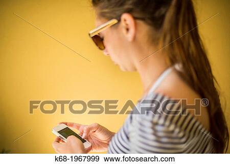 young woman, 21, using a phone. View Large Photo Image Stock Photo - young woman, 21, using a phone.. Fotosearch