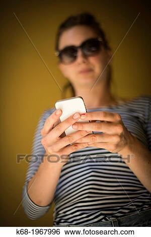 young woman, 21, using a phone. View Large Photo Image Stock Photograph - young woman, 21, using a phone.. Fotosearch