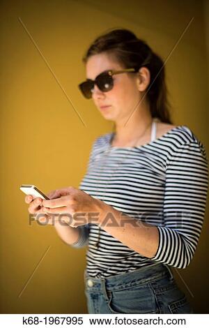 young woman, 21, using a phone. View Large Photo Image Stock Photography - young woman, 21, using a phone.. Fotosearch