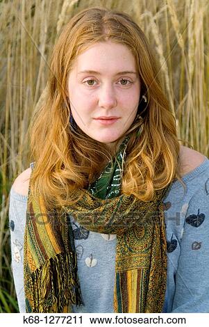young woman about 20 years of age outdoors with grasses behind her View Large Photo Image Stock Image - young woman about 20 years of age outdoors with grasses behind her. Fotosearch