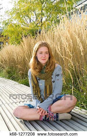 young woman about 20 years of age outdoors with grasses behind her View Large Photo Image Stock Photo - young woman about 20 years of age outdoors with grasses behind her. Fotosearch