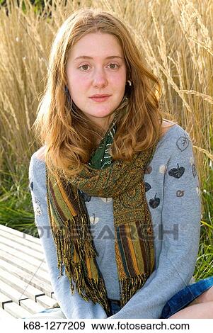 young woman about 20 years of age outdoors with grasses behind her View Large Photo Image Stock Photo - young woman about 20 years of age outdoors with grasses behind her. Fotosearch