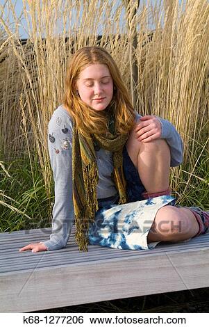 young woman about 20 years of age outdoors with grasses behind her View Large Photo Image Stock Photograph - young woman about 20 years of age outdoors with grasses behind her. Fotosearch