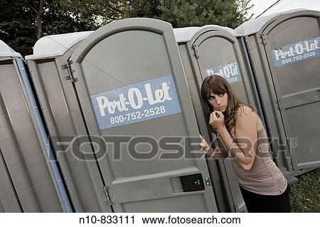 Young woman about to enter a portable toilet. View Large Photo Image Stock Image - Young woman about to enter a portable toilet.. Fotosearch