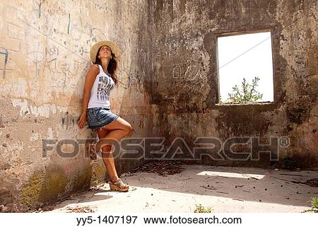 Young woman against wall View Large Photo Image Stock Photo - Young woman against wall. Fotosearch