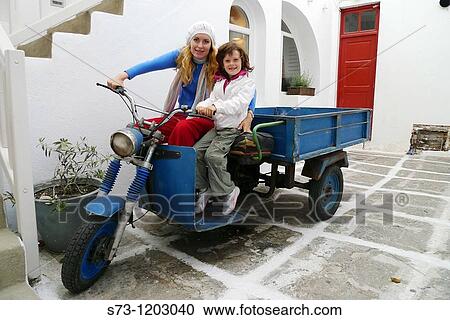 Young woman and 7 years old girl in a motorcycle in Mykonos, Cyclades Islands, Greece View Large Photo Image Stock Image - Young woman and 7 years old girl in a motorcycle in Mykonos, Cyclades Islands, Greece. Fotosearch