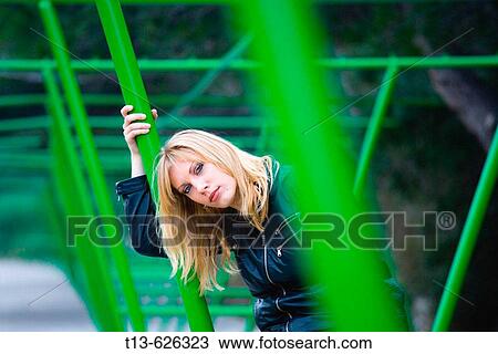 Stock Image - Young woman and bright Green car parking structure. Fotosearch