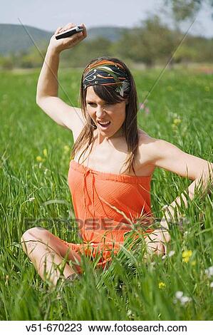 Young woman angry and tired of the mobile View Large Photo Image Stock Image - Young woman angry and tired of the mobile. Fotosearch