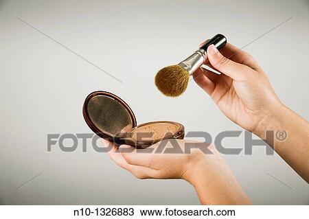 Young woman applying makeup View Large Photo Image Stock Image - Young woman applying makeup. Fotosearch