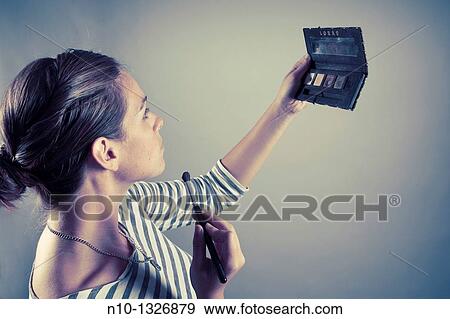 Young woman applying makeup View Large Photo Image Stock Photo - Young woman applying makeup. Fotosearch