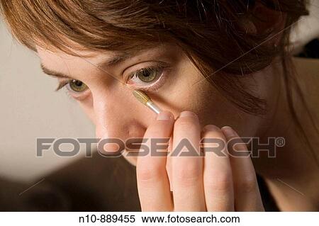 Young woman applying makeup. View Large Photo Image Stock Photography - Young woman applying makeup.. Fotosearch