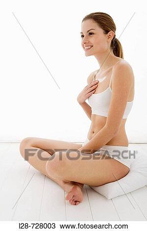 young woman applying moisturizer on her leg View Large Photo Image Stock Image - young woman applying moisturizer on her leg. Fotosearch