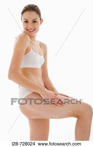 Young woman applying moisturizer View Large Photo Image Picture - Young woman applying moisturizer. Fotosearch