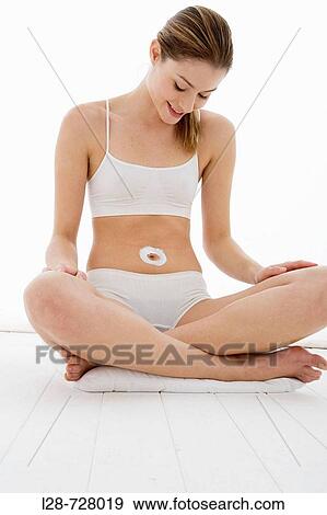 young woman applying moisturizer View Large Photo Image Stock Photo - young woman applying moisturizer. Fotosearch