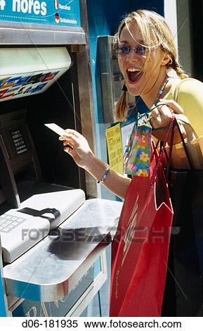 Young woman at cash dispenser View Large Photo Image Stock Photography - Young woman at cash dispenser. Fotosearch