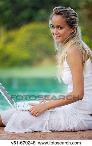Young woman at pool using laptop View Large Photo Image Stock Photo - Young woman at pool using laptop. Fotosearch