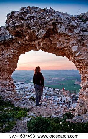 Young woman at sunset with views of Teba and his church, from the ruins castle Teba, Malaga, Andalusia, Spain View Large Photo Image Stock Image - Young woman at sunset with views of Teba and his church, from the ruins castle Teba, Malaga, Andalusia, Spain. Fotosearch