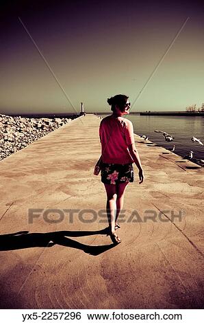 Young woman at the lake shore. View Large Photo Image Stock Photograph - Young woman at the lake shore.. Fotosearch