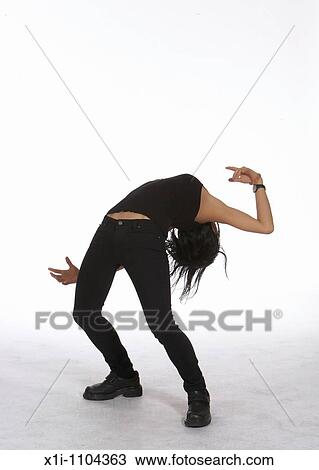 Stock Image - Young woman bending backwards. Fotosearch
