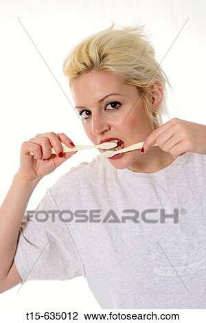 Young woman brushing her teeth with two tooth brushes, funny, humor View Large Photo Image Stock Image - Young woman brushing her teeth with two tooth brushes, funny, humor. Fotosearch