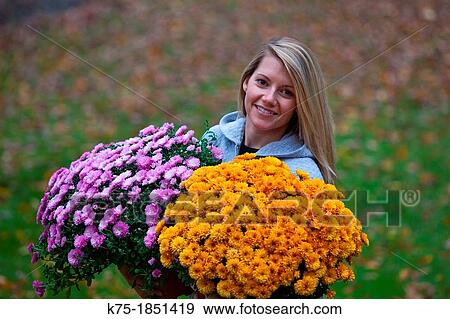 Young woman carrying two baskets of flowers View Large Photo Image Stock Photo - Young woman carrying two baskets of flowers. Fotosearch