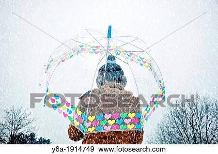 Young woman caught up in a snow storm View Large Photo Image Stock Photo - Young woman caught up in a snow storm. Fotosearch