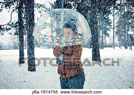 Young woman caught up in a snow storm View Large Photo Image Stock Photography - Young woman caught up in a snow storm. Fotosearch