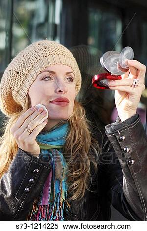 Young woman checking makeup View Large Photo Image Stock Photography - Young woman checking makeup. Fotosearch